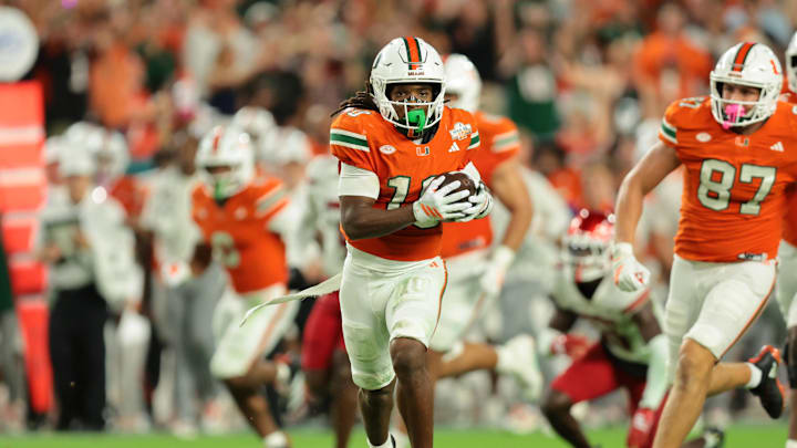 Oct 17, 2025; Miami Gardens, Florida, USA; Miami Hurricanes wide receiver Malachi Toney (10) carries the football against the Louisville Cardinals during the second quarter at Hard Rock Stadium. Mandatory Credit: Sam Navarro-Imagn Images
