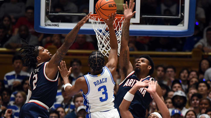 Nov 10, 2023; Durham, North Carolina, USA;  Duke Blue Devils guard Jeremy Roach (3) shoots over Arizona Wildcats guard Caleb Love (2) during the first half at Cameron Indoor Stadium. Mandatory Credit: Rob Kinnan-Imagn Images