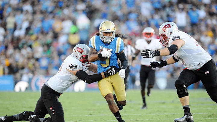 UCLA Bruins defensive back  runs the ball back after an interception against the UNLV Rebels. Mandatory Credit: Gary A. Vasquez-Imagn Images