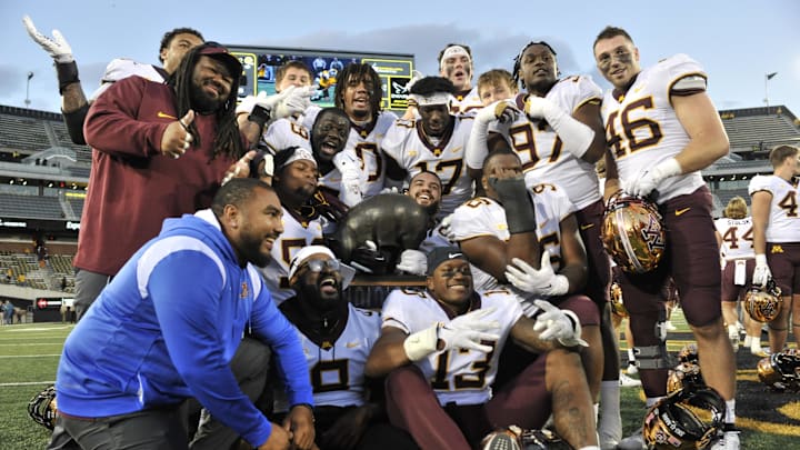 Oct 21, 2023; Iowa City, Iowa, USA; The Minnesota Golden Gophers hold the Floyd of Rosedale trophy after the game against the Iowa Hawkeyes at Kinnick Stadium. Mandatory Credit: Jeffrey Becker-Imagn Images