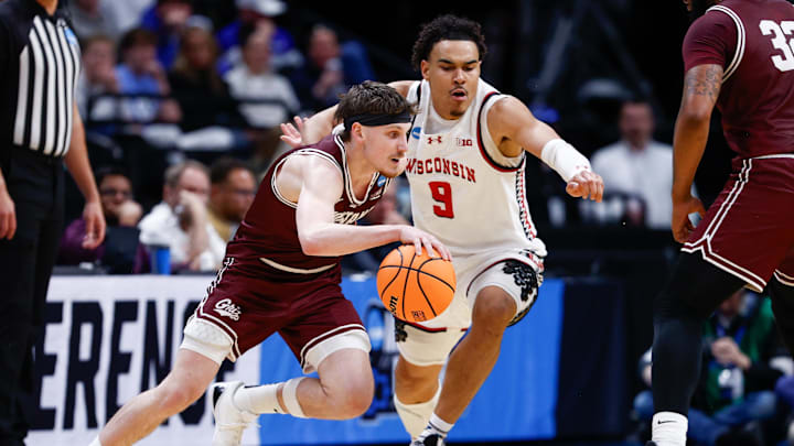 Montana Grizzlies guard Kai Johnson drives to the basket against Wisconsin Badgers guard John Tonje. Mandatory Credit: Isaiah J. Downing-Imagn Images