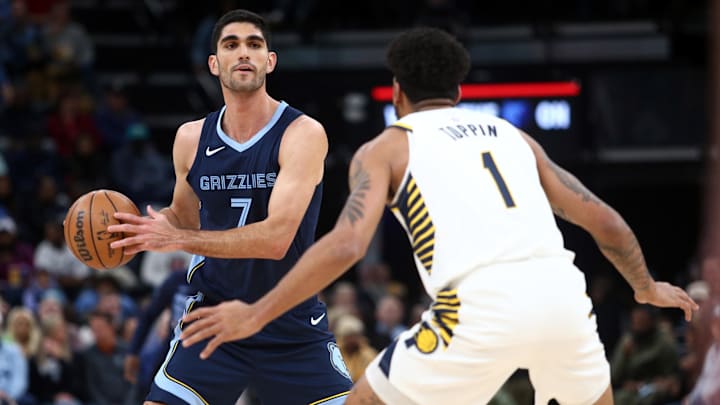 Dec 21, 2023; Memphis, Tennessee, USA; Memphis Grizzlies forward-center Santi Aldama (7) handles the ball as Indiana Pacers forward Obi Toppin (1) defends during the first half at FedExForum. Mandatory Credit: Petre Thomas-Imagn Images
