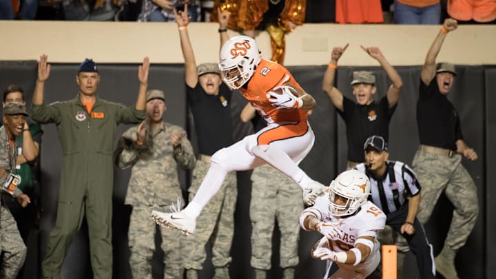 Oct 27, 2018; Stillwater, OK, USA; Oklahoma State Cowboys wide receiver Tylan Wallace (2) touchdown while defended by Texas Longhorns defensive back Brandon Jones (19) during the first half at Boone Pickens Stadium. Mandatory Credit: Rob Ferguson-USA TODAY Sports Oct 27, 2018; Stillwater, OK, USA; Oklahoma State Cowboys wide receiver Tylan Wallace (2) touchdown while defended by Texas Longhorns defensive back Brandon Jones (19) during the first half at Boone Pickens Stadium. Mandatory Credit: Rob Ferguson-USA TODAY Sports