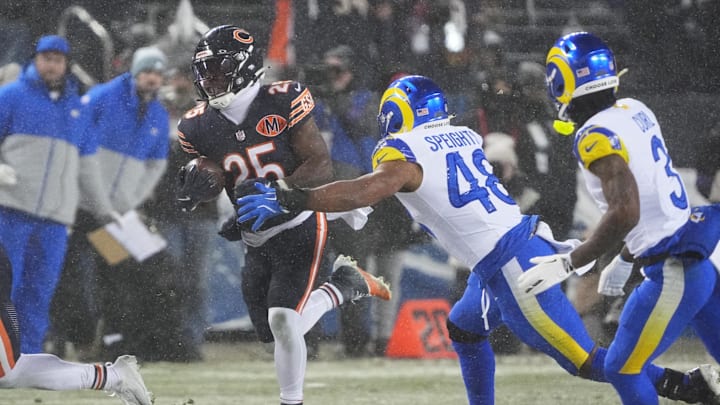 Jan 18, 2026; Chicago, IL, USA; Chicago Bears running back Kyle Monangai (25) runs with the ball against Los Angeles Rams linebacker Omar Speights (48) and safety Kam Curl (3) during the second quarter of an NFC Divisional Round game at Soldier Field. Mandatory Credit: David Banks-Imagn Images