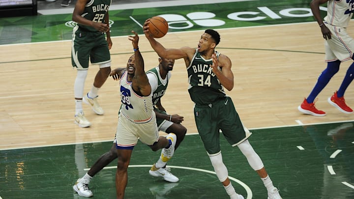 Apr 24, 2021; Milwaukee, Wisconsin, USA;  Milwaukee Bucks forward Giannis Antetokounmpo (34) grabs a rebound in front of Philadelphia 76ers center Dwight Howard (39) in the second quarter at Fiserv Forum. Mandatory Credit: Michael McLoone-Imagn Images