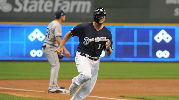 Milwaukee Brewers third baseman Mike Moustakas (11) rounds third base and scores in the first inning agains the San Diego Padres at Miller Park in 2019.