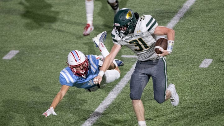 Basehor-Linwood senior Nick Doering throws down Shawnee Heights junior Cayden Lindsay in the second quarter of the game at Shawnee Heights High School on Friday, Sept. 20, 2024.