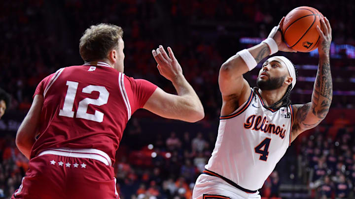 Feb 15, 2026; Champaign, Illinois, USA; Illinois Fighting Illini guard Kylan Boswell (4) looks to the basket as Indiana Hoosiers forward Tucker DeVries (12) defends during the first half at State Farm Center. Feb 15, 2026; Champaign, Illinois, USA; Illinois Fighting Illini guard Kylan Boswell (4) looks to the basket as Indiana Hoosiers forward Tucker DeVries (12) defends during the first half at State Farm Center.