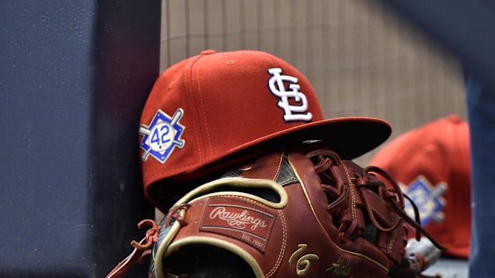 Apr 15, 2019; Milwaukee, WI, USA; A cap rests on the dug out wall with the number 42 on the hat in honor of Major League Baseball   s Jackie Robinson Day. Mandatory Credit: Michael McLoone-Imagn Images