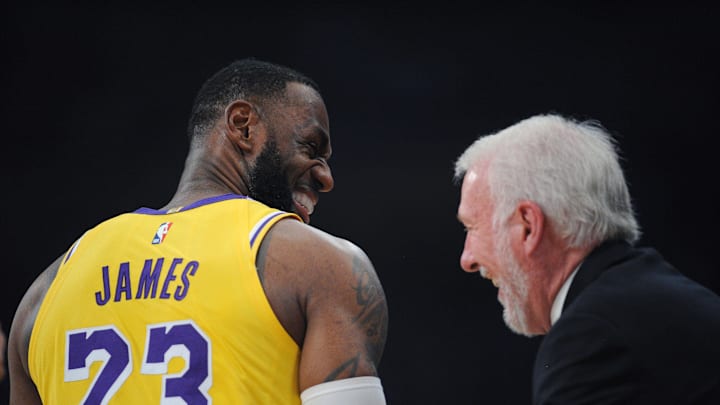 Los Angeles Lakers forward LeBron James shares a laugh with then San Antonio Spurs head coach Gregg Popovich in 2018.