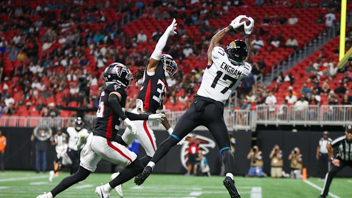 Aug 23, 2024; Atlanta, Georgia, USA; Jacksonville Jaguars tight end Evan Engram (17) catches a touchdown pass over Atlanta Falcons cornerback Jayden Price (36) and cornerback Kevin King (32) in the first quarter at Mercedes-Benz Stadium. 