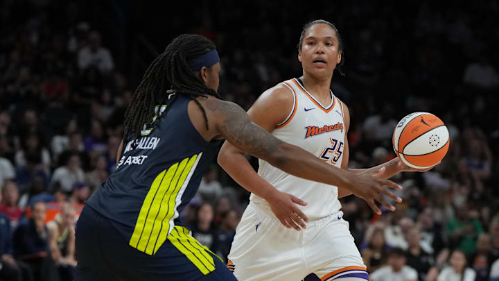 Jul 7, 2025; Phoenix, Arizona, USA; Phoenix Mercury forward Alyssa Thomas (25) looks to pass around Dallas Wings forward Myisha Hines-Allen (2) in the second half at Footprint Center. Mandatory Credit: Rick Scuteri-Imagn Images