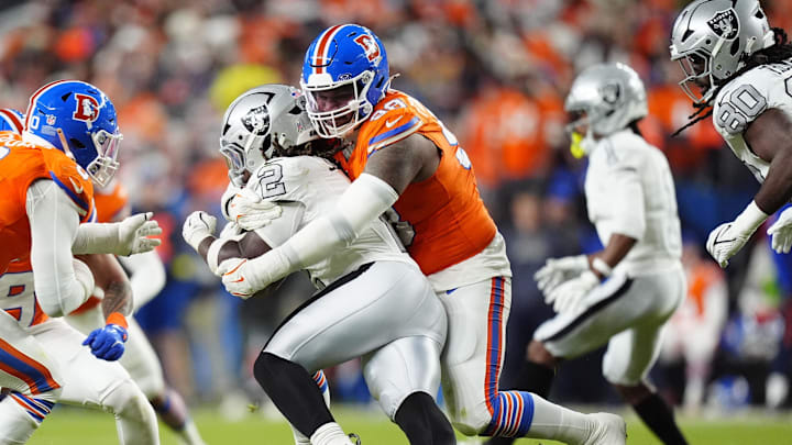 Nov 6, 2025; Denver, Colorado, USA; Denver Broncos defensive end John Franklin-Myers (98) makes a tackle on Las Vegas Raiders running back Ashton Jeanty (2) during the second half at Empower Field at Mile High. Mandatory Credit: Ron Chenoy-Imagn Images Nov 6, 2025; Denver, Colorado, USA; Denver Broncos defensive end John Franklin-Myers (98) makes a tackle on Las Vegas Raiders running back Ashton Jeanty (2) during the second half at Empower Field at Mile High. Mandatory Credit: Ron Chenoy-Imagn Images