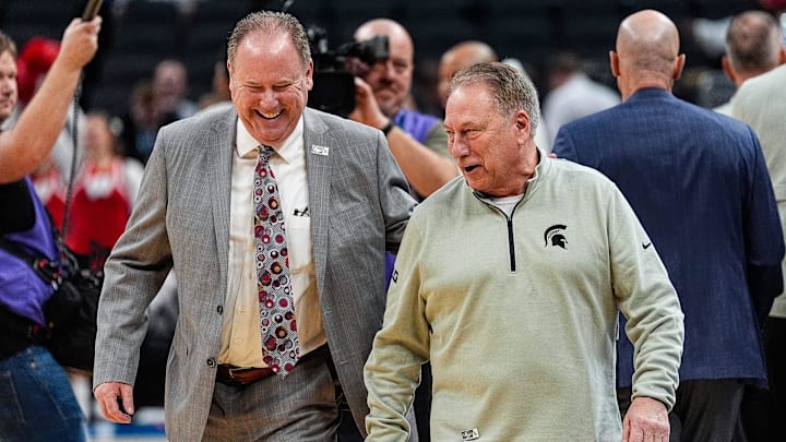 Wisconsin head coach Greg Gard, left, shares a laughter with Michigan State head coach Tom Izzo before tipoff of the first half of Big Ten Tournament semifinal at Gainbridge Fieldhouse in Indianapolis, Ind. on Saturday, March 15, 2025.