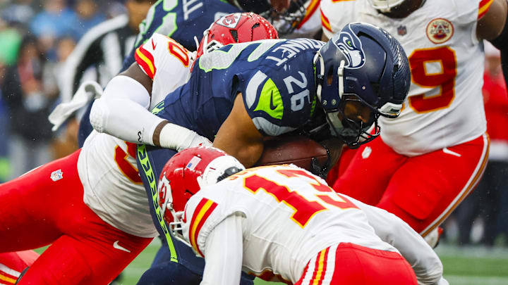 Aug 15, 2025; Seattle, Washington, USA; Seattle Seahawks running back Zach Charbonnet (26) rushes against the Kansas City Chiefs during the first quarter at Lumen Field. Mandatory Credit: Joe Nicholson-Imagn Images