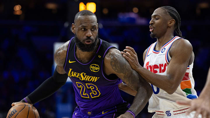 Jan 28, 2025; Philadelphia, Pennsylvania, USA; Los Angeles Lakers forward LeBron James (23) controls the ball against Philadelphia 76ers guard Tyrese Maxey (0) during the second quarter at Wells Fargo Center. Mandatory Credit: Bill Streicher-Imagn Images