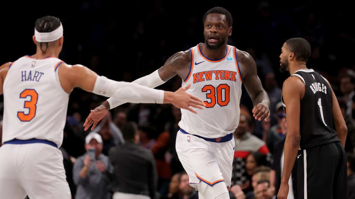 Jan 23, 2024; Brooklyn, New York, USA; New York Knicks forward Julius Randle (30) high fives guard Josh Hart (3) in front of Brooklyn Nets forward Mikal Bridges (1) during the fourth quarter at Barclays Center. Mandatory Credit: Brad Penner-USA TODAY Sports