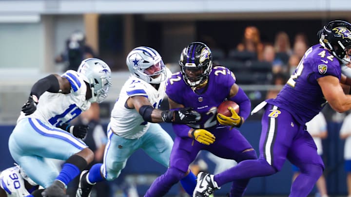 Sep 22, 2024; Arlington, Texas, USA;  Baltimore Ravens running back Derrick Henry (22) runs with the ball as Dallas Cowboys linebacker Micah Parsons (11) defends during the second half at AT&T Stadium. Mandatory Credit: Kevin Jairaj-Imagn Images
