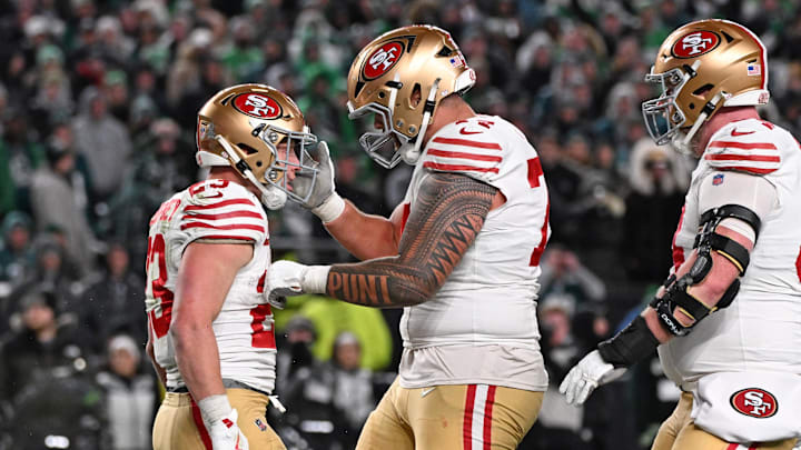 Jan 11, 2026; Philadelphia, PA, USA; San Francisco 49ers running back Christian McCaffrey (23) celebrates his touchdown catch with guard Spencer Burford (74) against the Philadelphia Eagles during the fourth quarter in an NFC Wild Card Round game at Lincoln Financial Field. Mandatory Credit: Eric Hartline-Imagn Images