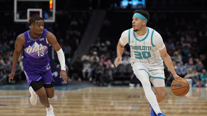 Mar 31, 2025; Charlotte, North Carolina, USA; Charlotte Hornets guard Seth Curry (30) brings the ball up court defended by Utah Jazz guard Isaiah Collier (13) during the first quarter at Spectrum Center. Mandatory Credit: Jim Dedmon-Imagn Images