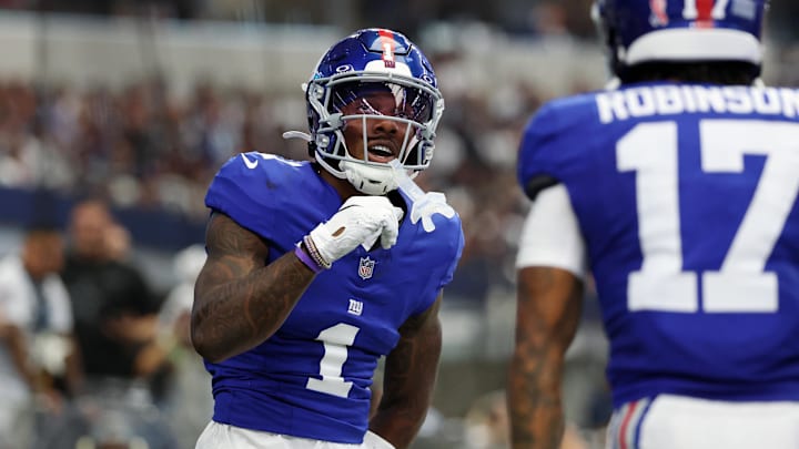 Sep 14, 2025; Arlington, Texas, USA; New York Giants wide receiver Malik Nabers (1) celebrates after scoring a touchdown against the Dallas Cowboys during the second quarter at AT&T Stadium. 