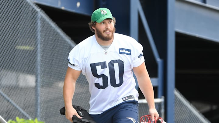 May 23, 2022; Foxborough, MA, USA; New England Patriots offensive lineman Cole Strange (50) walks to the practice field for the team's OTA at Gillette Stadium. Mandatory Credit: Eric Canha-Imagn Images