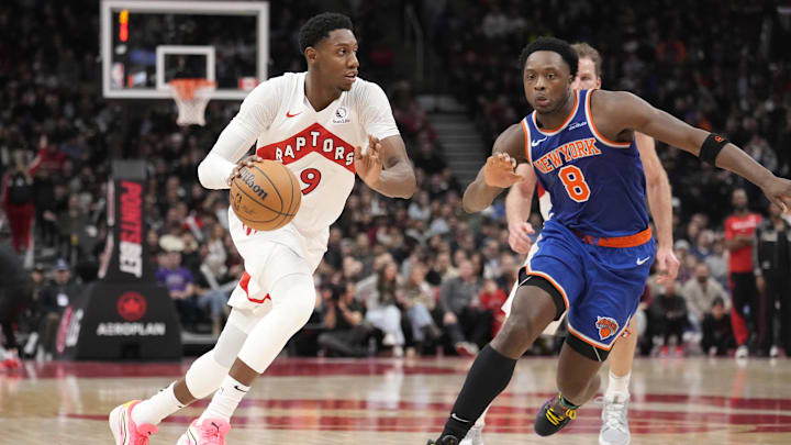 Dec 9, 2024; Toronto, Ontario, CAN; Toronto Raptors guard RJ Barrett (9) drives against New York Knicks forward OG Anunoby (8) during the second half at Scotiabank Arena. Mandatory Credit: John E. Sokolowski-Imagn Images
