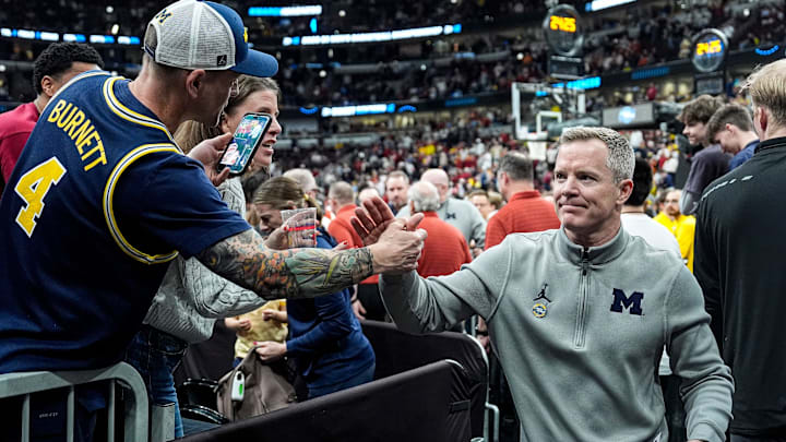 Michigan head coach Dusty May shakes hands with fans to celebrate 90-77 win over Alabama at the NCAA Tournament Sweet 16 round at United Center in Chicago on Friday, March 27, 2026.