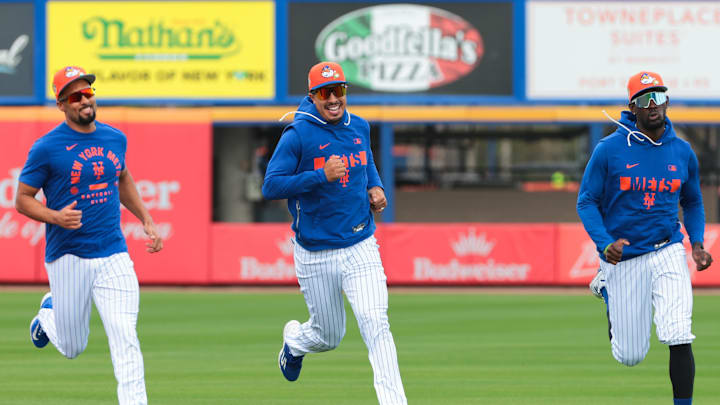 Feb 17, 2026; Port St. Lucie, FL, USA; New York Mets infielder Marcus Semien (left), infielder Mark Vientos (center) and infielder Ronny Mauricio (right) run on the field during spring training at Clover Park. Mandatory Credit: Sam Navarro-Imagn Images