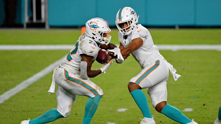 Miami Dolphins quarterback Tua Tagovailoa (1) hands the ball to running back Matt Breida (22) during the second half against the New York Jets at Hard Rock Stadium. 
