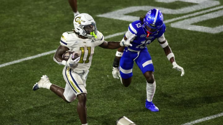 Aug 31, 2024; Atlanta, Georgia, USA; Georgia Tech Yellow Jackets running back Jamal Haynes (11) runs the ball past Georgia State Panthers safety Isaiah Holland (13) in the second quarter at Bobby Dodd Stadium at Hyundai Field. Mandatory Credit: Brett Davis-USA TODAY Sports Aug 31, 2024; Atlanta, Georgia, USA; Georgia Tech Yellow Jackets running back Jamal Haynes (11) runs the ball past Georgia State Panthers safety Isaiah Holland (13) in the second quarter at Bobby Dodd Stadium at Hyundai Field. Mandatory Credit: Brett Davis-USA TODAY Sports