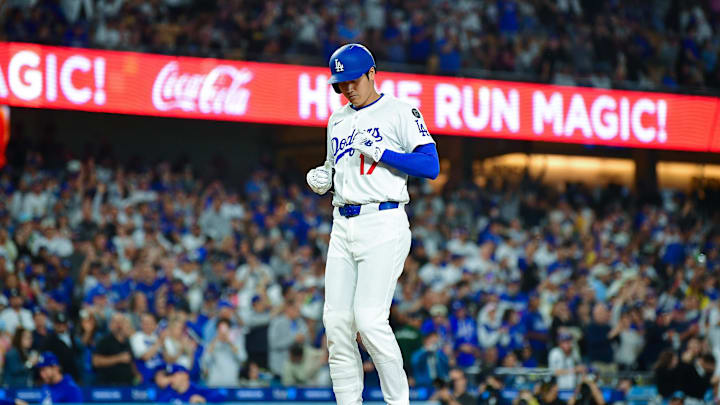 Los Angeles Dodgers designated hitter Shohei Ohtani (17) touches home after hitting a solo home run against the Arizona Diamondbacks during the sixth inning at Dodger Stadium on May 19.
