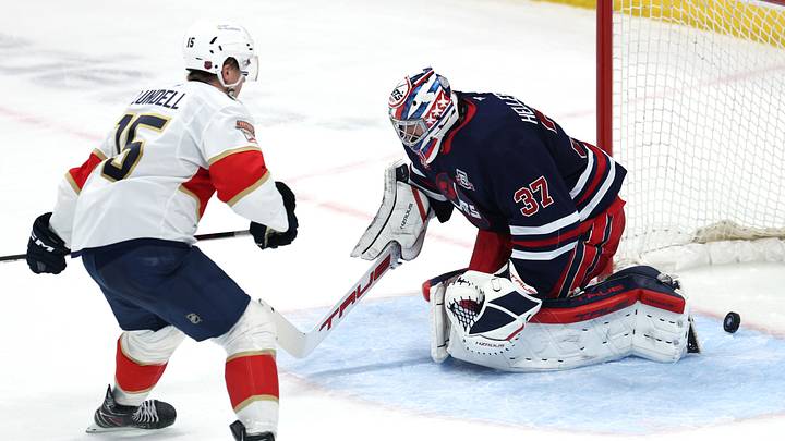 Jan 22, 2026; Winnipeg, Manitoba, CAN; Florida Panthers center Anton Lundell (15) scores the game-winning goal on Winnipeg Jets goaltender Connor Hellebuyck (37) in the shootout at Canada Life Centre. Mandatory Credit: James Carey Lauder-Imagn Images