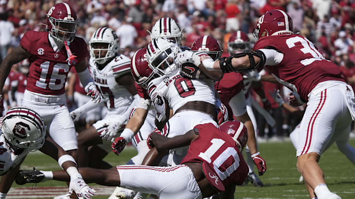 Oct 12, 2024; Tuscaloosa, Alabama, USA;  South Carolina Gamecocks running back Juju McDowell (0) is wrapped up by Alabama defenders at Bryant-Denny Stadium. Alabama defeated South Carolina 27-25. Mandatory Credit: Gary Cosby Jr.-Imagn Images