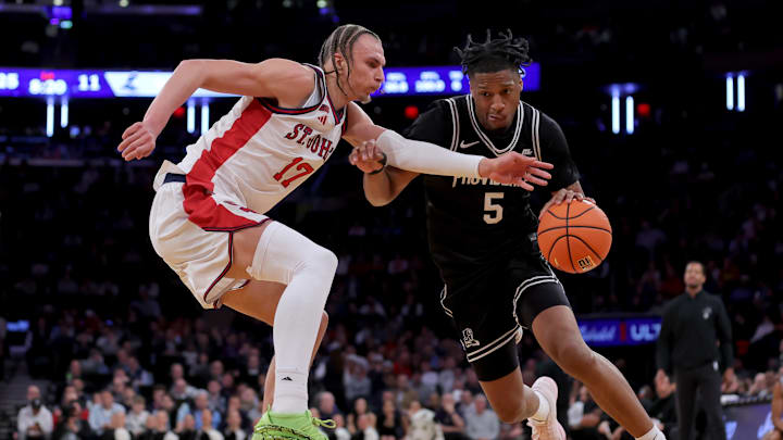 Mar 12, 2026; New York, NY, USA; Providence Friars forward Jamier Jones (5) drives to the basket against St. John's Red Storm forward Ruben Prey (17) during the first half at Madison Square Garden. Mandatory Credit: Brad Penner-Imagn Images