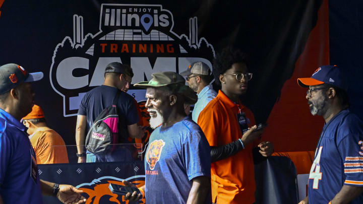 Bears fans enter a past training camp at Halas Hall. Tickets are free to camp but there were only a limited number available.
