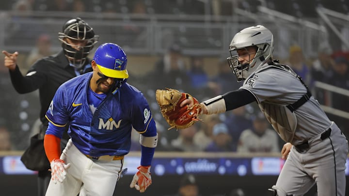 Sep 4, 2025; Minneapolis, Minnesota, USA; Minnesota Twins third baseman Royce Lewis (23) strikes out and attempts to steal first base but runs too far from Chicago White Sox catcher Kyle Teel (8) in the first inning at Target Field. Mandatory Credit: Bruce Kluckhohn-Imagn Images
