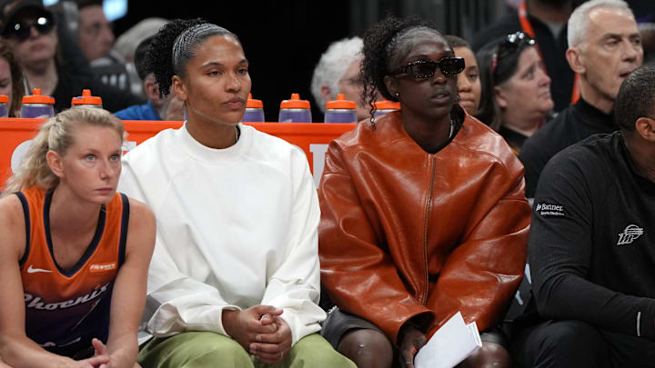 May 30, 2025; Phoenix, Arizona, USA; Phoenix Mercury forward Alyssa Thomas (25) and guard Kahleah Copper (2) watch game action against the Minnesota Lynx in the first half at Footprint Center. Mandatory Credit: Rick Scuteri-Imagn Images