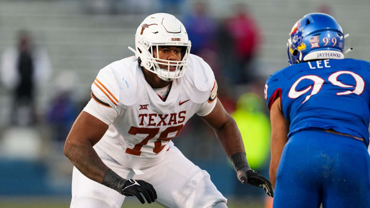 Nov 19, 2022; Lawrence, Kansas, USA; Texas Longhorns offensive lineman Kelvin Banks Jr. (78) looks to block Kansas Jayhawks defensive lineman Malcolm Lee (99) during the second half at David Booth Kansas Memorial Stadium. Mandatory Credit: Jay Biggerstaff-USA TODAY Sports