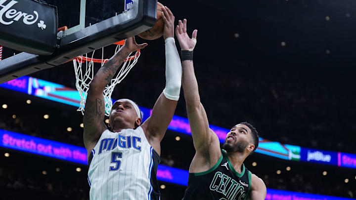 Apr 29, 2025; Boston, Massachusetts, USA; Boston Celtics forward Jayson Tatum (0) defends against Orlando Magic forward Paolo Banchero (5) in the second quarter during game five of first round for the 2025 NBA Playoffs at TD Garden. Mandatory Credit: David Butler II-Imagn Images