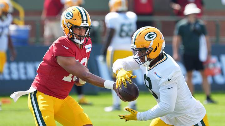 Green Bay Packers quarterback Jordan Love (10) hands off the ball to running back Josh Jacobs (8) during the fifth day of training camp on Aug. 3, 2026, at Ray Nitschke Field in Ashwaubenon, Wis.