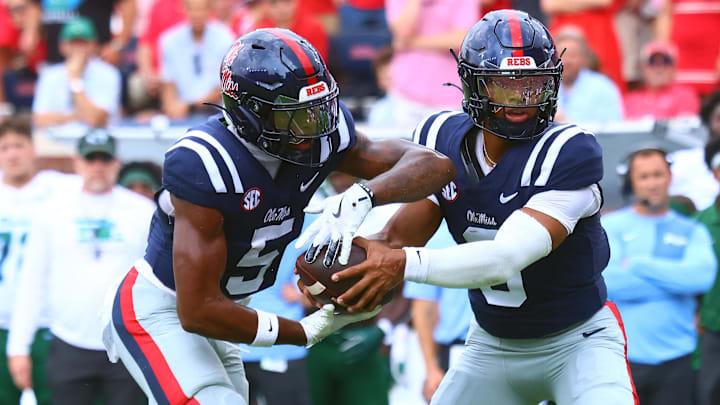 Sep 20, 2025; Oxford, Mississippi, USA; Mississippi Rebels quarterback Trinidad Chambliss (6) hands the ball off to running back Kewan Lacy (5) during the first quarter against the Tulane Green Wave at Vaught-Hemingway Stadium. Mandatory Credit: Petre Thomas-Imagn Images