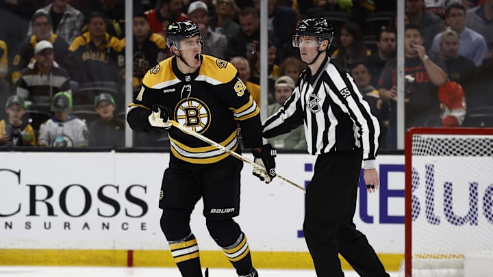 Mar 11, 2025; Boston, Massachusetts, USA; Boston Bruins defenseman Nikita Zadorov (91) is escorted to the penalty box after being called for a penalty during the third period against the Florida Panthers at TD Garden. Mandatory Credit: Winslow Townson-Imagn Images