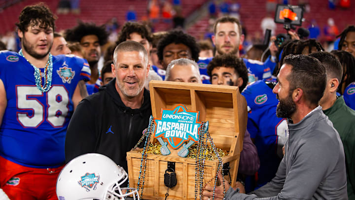 Florida Gators head coach Billy Napier lifts the 2024 Union Home Mortgage Gasparilla Bowl trophy in Raymond James Stadium in Tampa, FL on Friday, December 20, 2024 after defeating Tulane 33-8. [Doug Engle/Gainesville Sun]