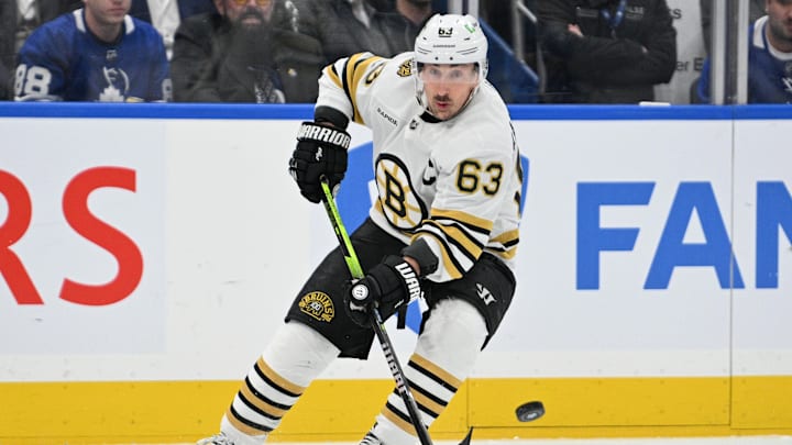 May 2, 2024; Toronto, Ontario, CAN;   Boston Bruins forward Brad Marchand (63) passes the puck against the Toronto Maple Leafs in the first period in game six of the first round of the 2024 Stanley Cup Playoffs at Scotiabank Arena. Mandatory Credit: Dan Hamilton-Imagn Images