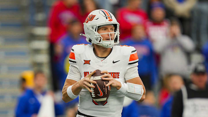 Nov 1, 2025; Lawrence, Kansas, USA; Oklahoma State Cowboys quarterback Zane Flores (6) drops back to pass during the second half against the Kansas Jayhawks at David Booth Kansas Memorial Stadium. Mandatory Credit: Jay Biggerstaff-Imagn Images Nov 1, 2025; Lawrence, Kansas, USA; Oklahoma State Cowboys quarterback Zane Flores (6) drops back to pass during the second half against the Kansas Jayhawks at David Booth Kansas Memorial Stadium. Mandatory Credit: Jay Biggerstaff-Imagn Images