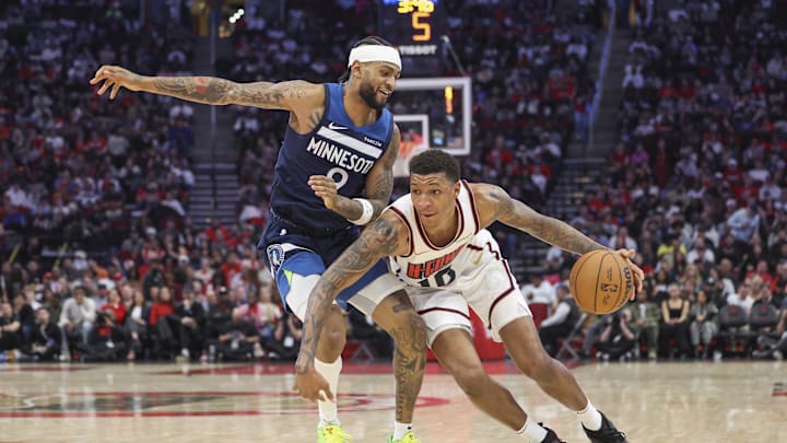 Dec 27, 2024; Houston, Texas, USA; Houston Rockets forward Jabari Smith Jr. (10) dribbles the ball as Minnesota Timberwolves guard Nickeil Alexander-Walker (9) defends during the third quarter at Toyota Center. Mandatory Credit: Troy Taormina-Imagn Images