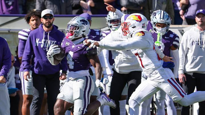 Oct 17, 2026; Manhattan, Kansas, USA; Kansas State Wildcats running back Joe Jackson (4) is pulled down by Kansas Jayhawks safety Taylor Davis (27) during the fourth quarter at Bill Snyder Family Football Stadium. Mandatory Credit: Scott Sewell-Imagn Images Oct 17, 2026; Manhattan, Kansas, USA; Kansas State Wildcats running back Joe Jackson (4) is pulled down by Kansas Jayhawks safety Taylor Davis (27) during the fourth quarter at Bill Snyder Family Football Stadium. Mandatory Credit: Scott Sewell-Imagn Images