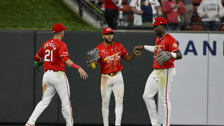 Apr 25, 2025; St. Louis, Missouri, USA;  St. Louis Cardinals center fielder Victor Scott II (11) left fielder Lars Nootbaar (21) and right fielder Jordan Walker (18) celebrate after the Cardinals defeated the Milwaukee Brewers at Busch Stadium. Mandatory Credit: Jeff Curry-Imagn Images
