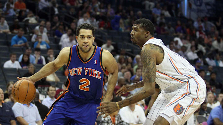 New York Knicks guard Landry Fields drives the ball to the basket while being defended by Charlotte Bobcats power forward Tyrus Thomas. Mandatory Credit: Jeremy Brevard-Imagn Images
